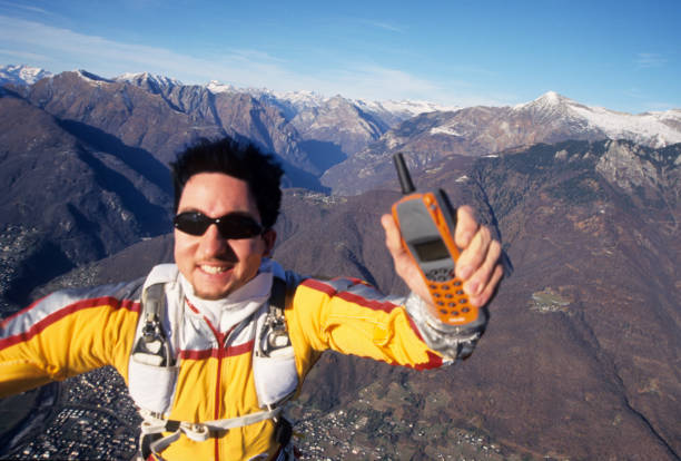 He is holding an older mobile phone