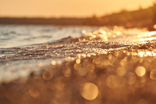 little waves on the sunset light lake goldenhour beach relax rest holiday vacation bokehlight sprinkle golden flares