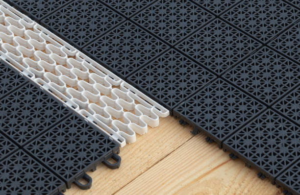 istock Puzzle flooring, black and white - modular plastic or polymer flooring with holes 1483256242