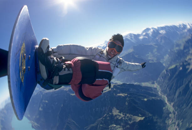 istock Portrait of skydiver on skyboard above mountains 1483256716