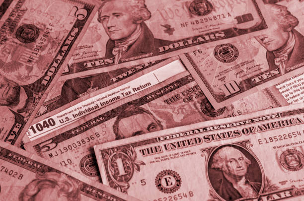 istock IRS form 1040 and dollars still life background 1483257279