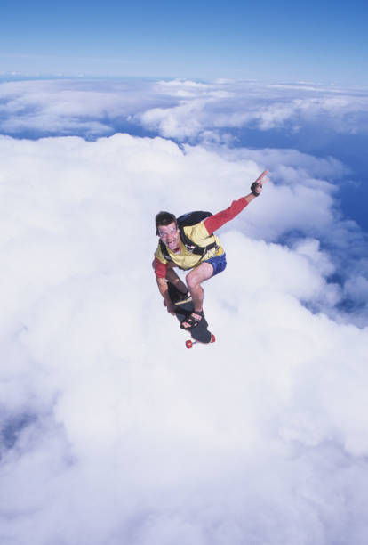 skydiver surfa l'aria su uno skateboard - skydiving air aerial view vertical foto e immagini stock