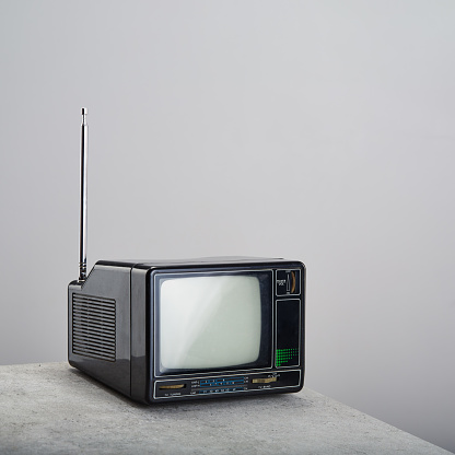 Old vintage television on white. Retro portable tv receiver with antenna on white background