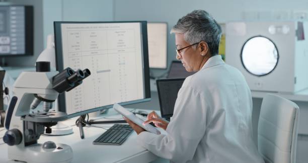 istock Research, tablet and mature scientist working on an analysis or a science project in an office or lab using technology. Professional, computer and woman technician reading experiment results online 1483266787