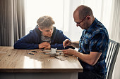 Father and son repairing a drone at home