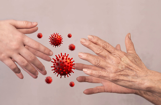 Infection with a virus through a handshake. Hands of an elderly woman and a young girl with a flying virus.