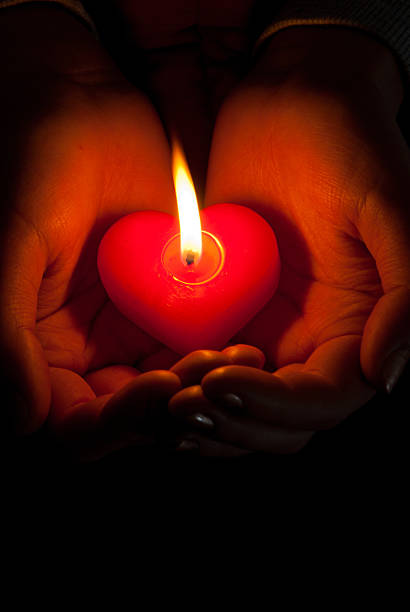 istock Human hands hold heart shaped burning candle 148327489