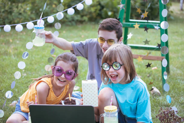 istock Happy children celebrating virtual birthday party at backyard 1483275013