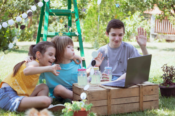 istock Happy children celebrating virtual birthday party at backyard 1483275800