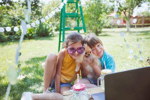 Happy children celebrating virtual birthday party at backyard