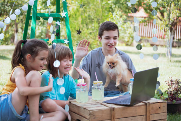 istock Happy children celebrating virtual birthday party at backyard 1483275845