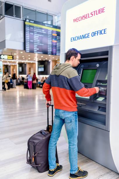 istock Tourist with a suitcase in front of an ATM 1483278966