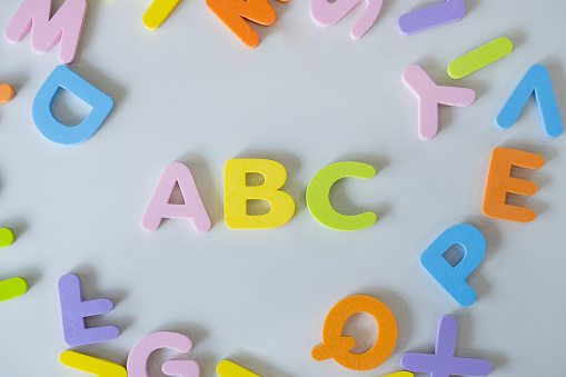 Colorful letters A, B, C and toy building block on  white background. Concept of education, back to school. Top view, flat lay .