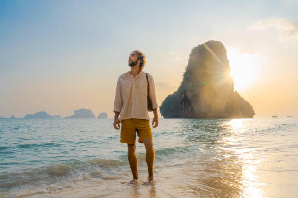 istock Man walking on Railey beach and looking at stunning scenery 1483280671