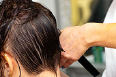 real female haircut in a beauty salon. woman hairdresser and client. women's business. initial combing of the wetted head