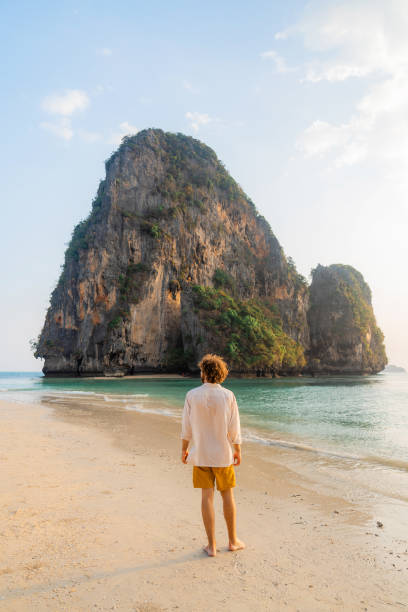istock Man walking on Railey beach and looking at stunning scenery 1483280910