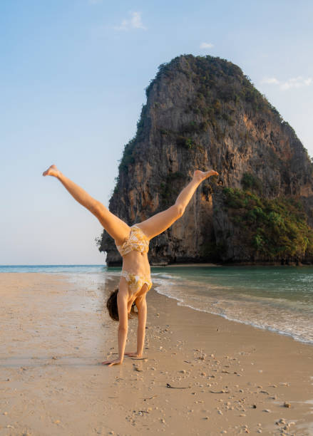 istock Woman  doing handstand on  Railey  beach in Krabi 1483280954