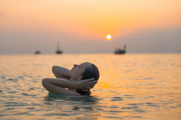 istock Woman swimming at sunset 1483281524