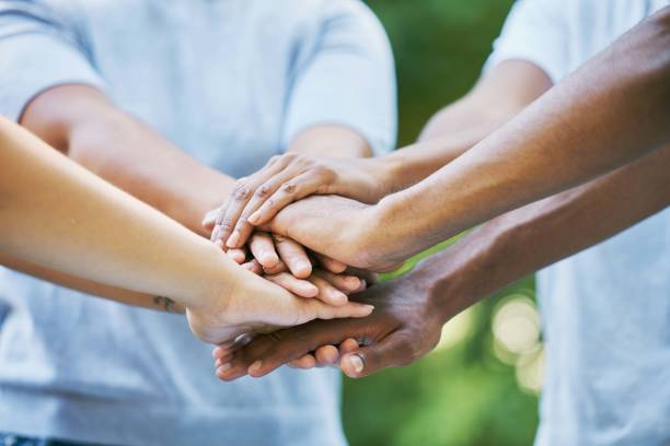 istock People, diversity and hands together for community, trust or collaboration in partnership in the outdoors. Hand of team piling or joining in unity for agreement, coordination or support in solidarity 1483282609