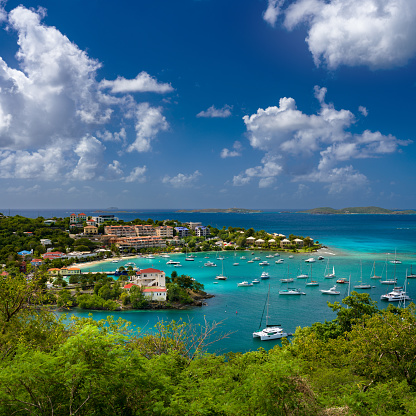 Beautiful horizontal image of St George's, cruise port in Grenada. Blue sky with white clouds, waterfront and bright buildings along the coastline.