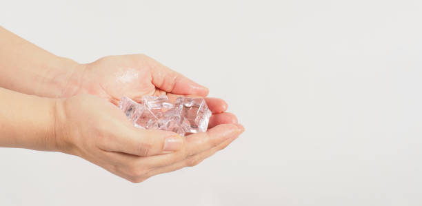istock Hand is holding ice cubes on white background. 1483283315