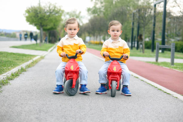 istock Twin brothers driving toy motorcycles 1483283544