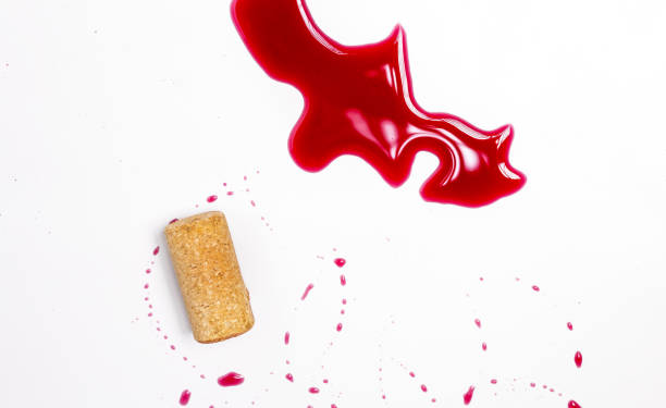 istock splashed wine on table heart shaped glass,cork and corkscrew isolated 1483291642