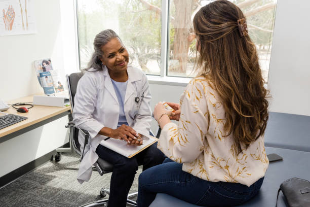 istock Female physician smiles as patient asks questions about medication 1483293043
