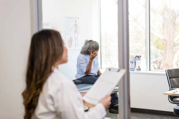 istock Focus on distressed patient as doctor walks into room 1483293079