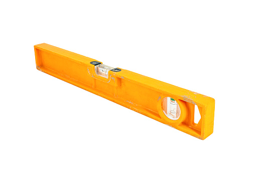 A used orange level of plastic in front of a white background
