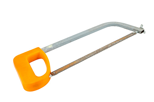 A rusty hacksaw with an orange handle against a white background
