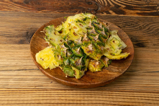 istock Pineapple Skin, Bio Garbage, Vegetable Waste, Pineapple Peel, Fruit Peeling Waste Pile, Organic Compost on Wood 1483294123