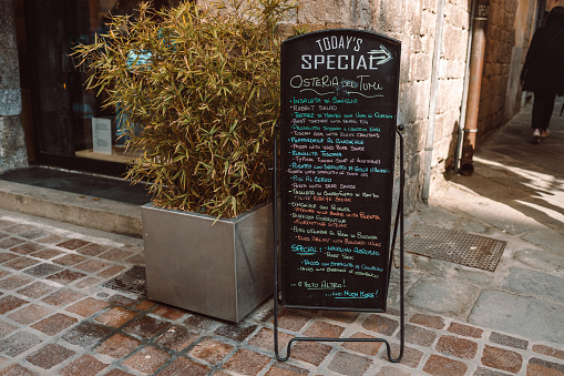 Chalkboard with menu and german food at door of restaurant bistro in Koblenz