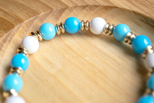 Bracelet made of white, blue and gold beads. A simple bracelet to make at home. Beautiful beaded brachslet.