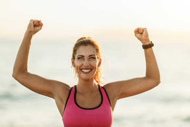 istock Woman Celebrating After Exercise At The Beach 1483297965