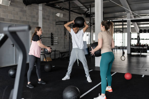 istock People Exercising in a Gym With Medicine Balls 1483298518