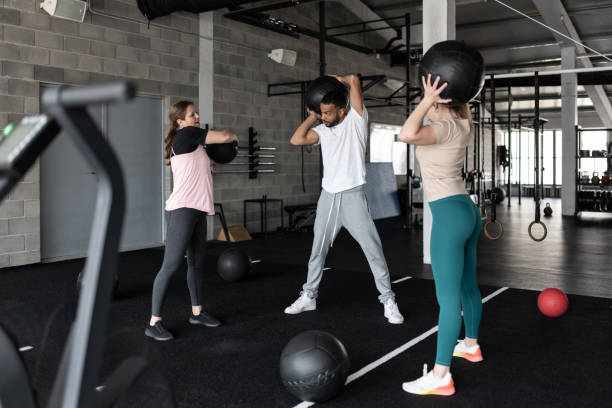 istock People Exercising in a Gym With Medicine Balls 1483298520