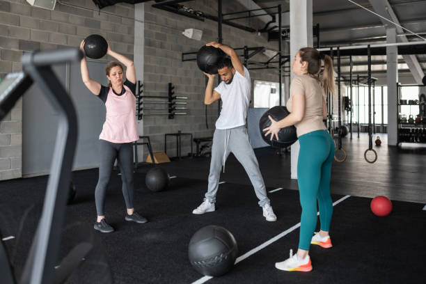 istock People Exercising in a Gym With Medicine Balls 1483298521