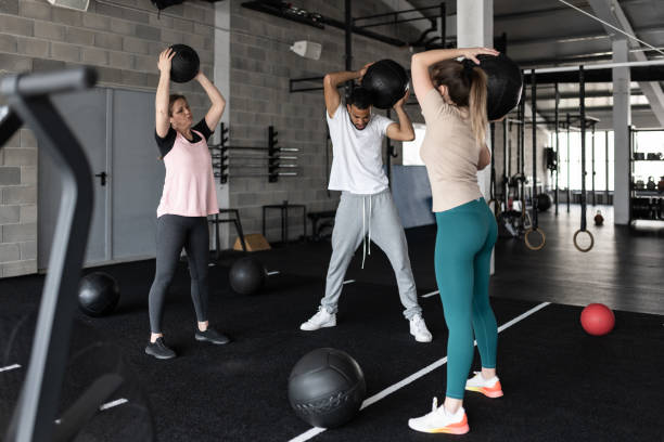 istock People Exercising in a Gym With Medicine Balls 1483298524