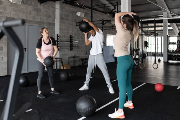 istock People Exercising in a Gym With Medicine Balls 1483298525