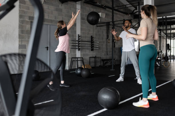 istock People Exercising in a Gym With Medicine Balls 1483298537