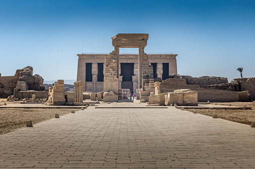 A young tourist visiting the Temple of Philae - shot from behind