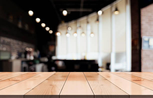 istock Empty wooden table top with lights bokeh on blur restaurant background. 1483302133