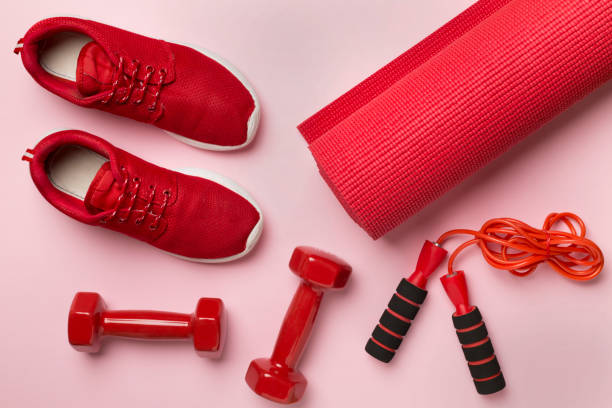 istock Red sport equipment on color background, top view 1483303000