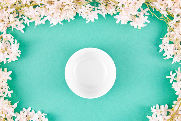 istock Empty Bowl On Turquoise Background With Jasmine Flowers 1483303599