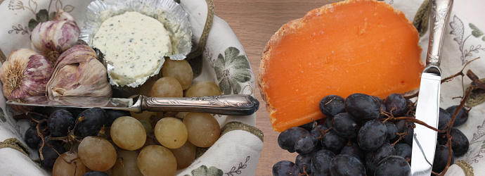 Mimolette and cheese spread with garlic and fine herbs  Black and white grapes  Meal buffet