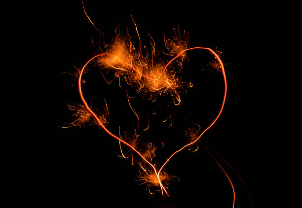 istock fiery heart with sparks on black background 1483305954