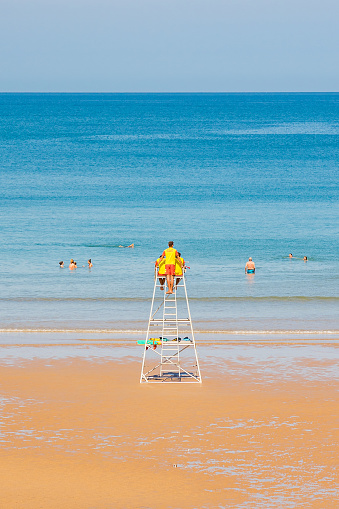 Lifeguards on their chair by the Atlantic ocean on the Cote des Basques beach in Biarritz, France in summer