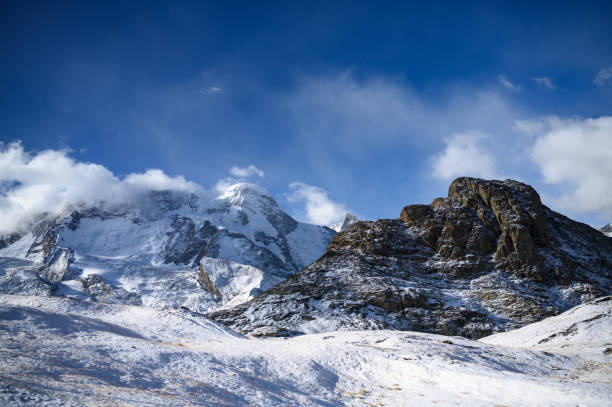 Panoramic view of towering mountains of Gornergrat covered with snow and clouds on a clear day. It is an image that shows the beauty of great nature suitable to attract tourists to visit uninterrupted.
