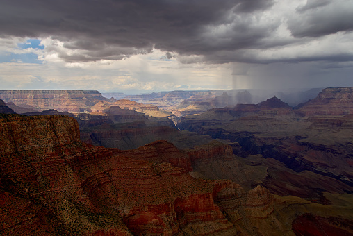 A thunderstorm dropping monsoonal rain over the Grand Canyon on a August afternoon, as seen from Moran Point on the south rim of canyon in Arizona, USA.